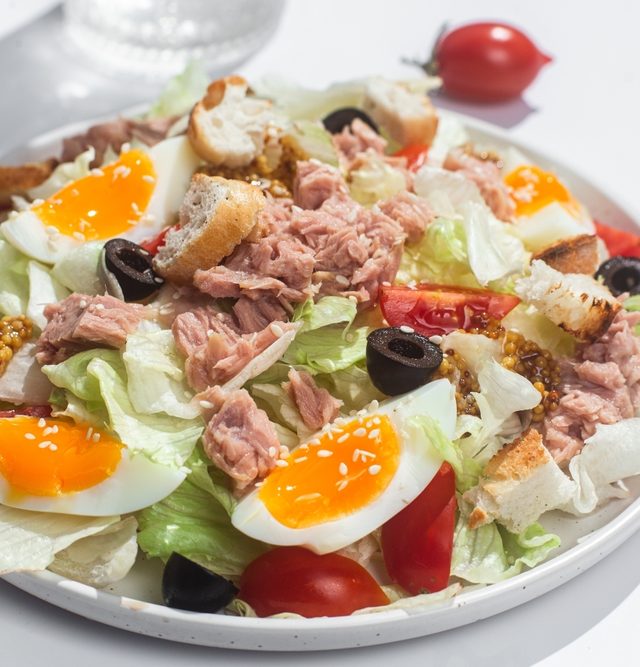 appetizing,salad,with,iceberg,,tuna,,boiled,eggs,in,a,white