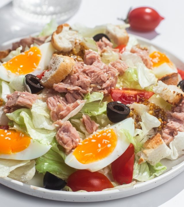appetizing,salad,with,iceberg,,tuna,,boiled,eggs,in,a,white